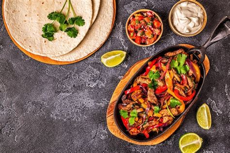 Premium Photo | Fajitas with colored pepper and onions served with ...