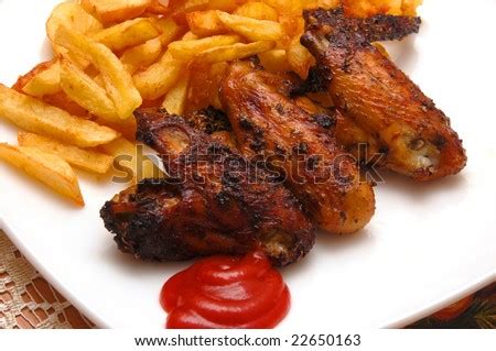 Grilled Chicken Wings On A White Plate With Chips. Stock Photo 22650163 ...