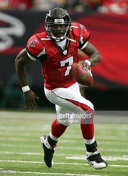 Michael Vick of the Atlanta Falcons runs upfield during their game ...