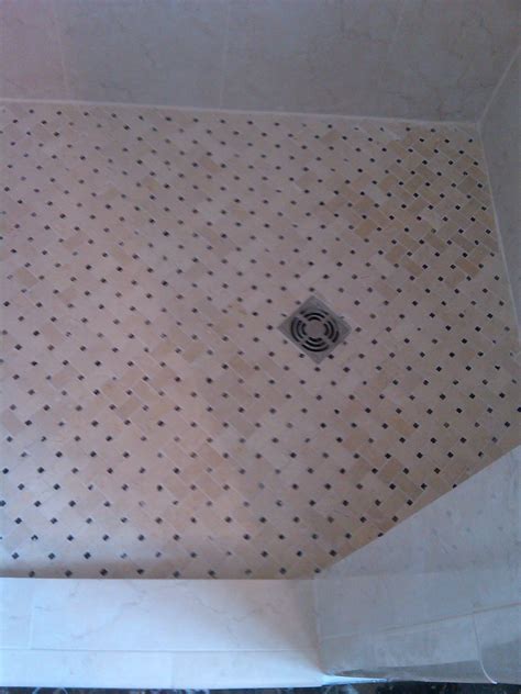 Shower floor. Notice the square drain grate.