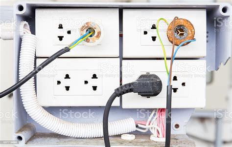 Electronic Power Plug With Unsafety Plugged In Wall Socket Stock Photo ...