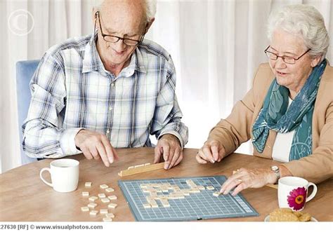 A senior couple playing a board game together - Activities For Seniors