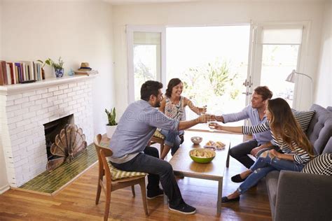 Couple Entertaining Friends At Home Stock Image Image Of Asian Mixed