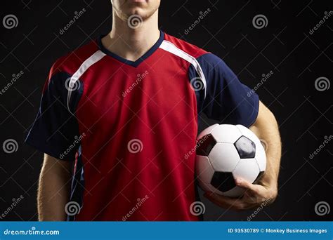 Close Up Of Professional Soccer Player With Ball In Studio Stock Image