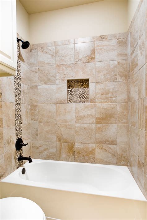 Generous walkin shower with bench seating has woodlook porcelain tile for the surround