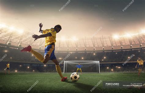 Football Player Shooting The Ball At The Goal — Asian Professional