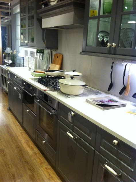 This kitchen features light grey cabinetry, white granite countertops and white tile backsplashes. More of the grey/blue kitchen but white worktops. Prefer ...