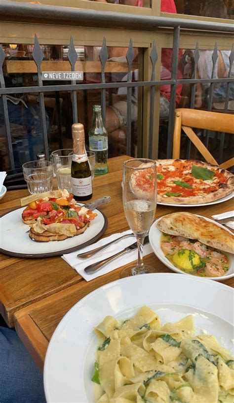 Plates Of Food And Wine On A Wooden Table