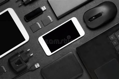 Electronic Gadgets On A Black Concrete Background Concept Of