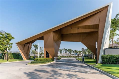 A Large Wooden Structure Sitting On Top Of A Lush Green Field Next To A