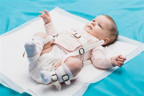 A Baby Wearing A Harness That Corrects Hip Dysplasia Stock Image