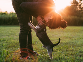 A woman kissing her dog