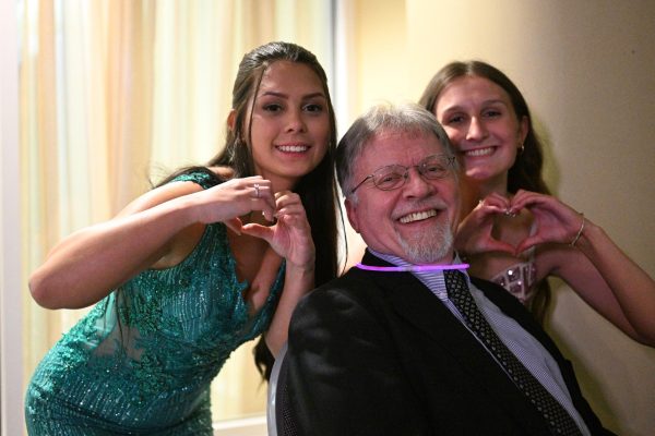 TAHS students Mariyah Hunter and Cami Weyer expressing their affection and appreciation for Mr. McNitt at this year's prom. 