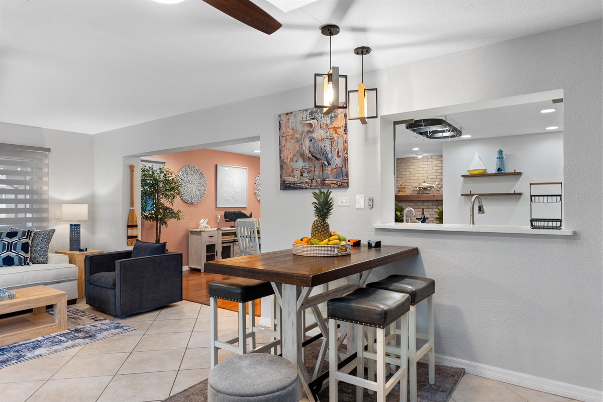 The dining counter invites conversation and connection, allowing everyone to gather and enjoy meals together while remaining close to the action in the kitchen.