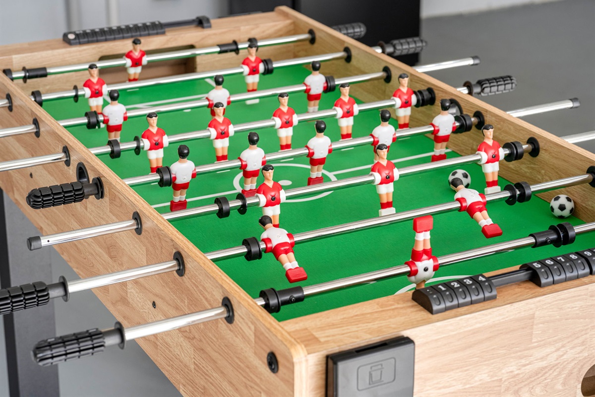 The foosball table invites you to engage in fast-paced action, challenging friends and family to a game of skill and strategy.