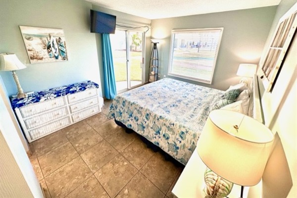 Master bedroom with King bed, on suite bathroom, and sliding patio door..