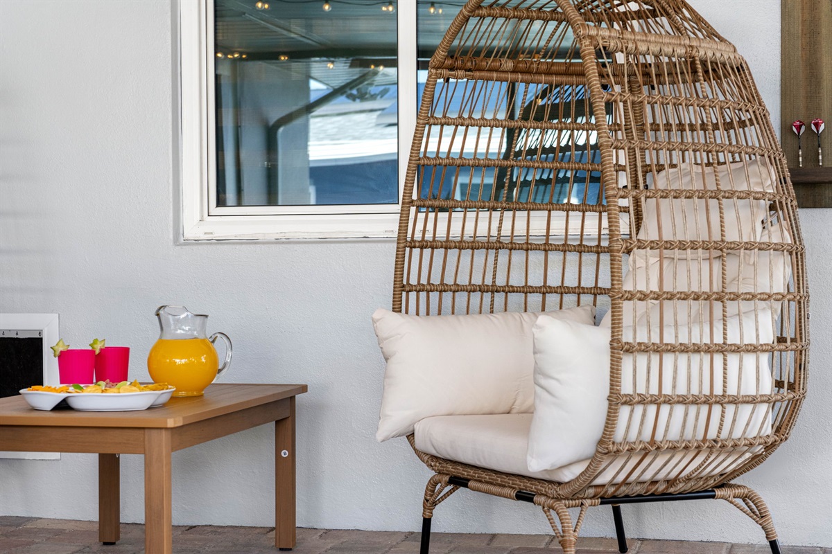 To enhance the comfort and versatility of the space, there are several basket chairs scattered throughout the patio.