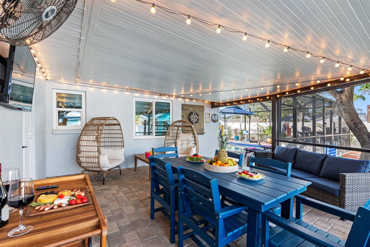 Step into the beautifully designed covered patio, a perfect blend of comfort and style, offering multiple seating arrangements for everyone to enjoy.