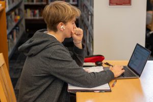 Sophomore Ian Benert completes homework in the library during his free period. Many Lab students juggle work and extracurriculars outside of class, yet rate their productivity and achievements significantly lower than Lab parents.