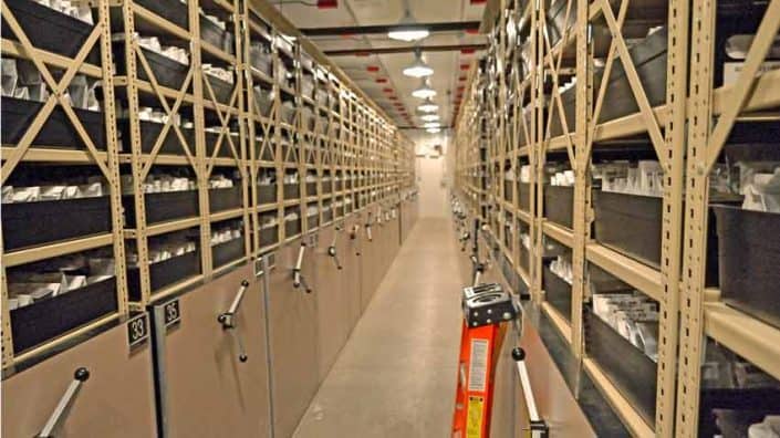 A long hallway with many shelves of books.