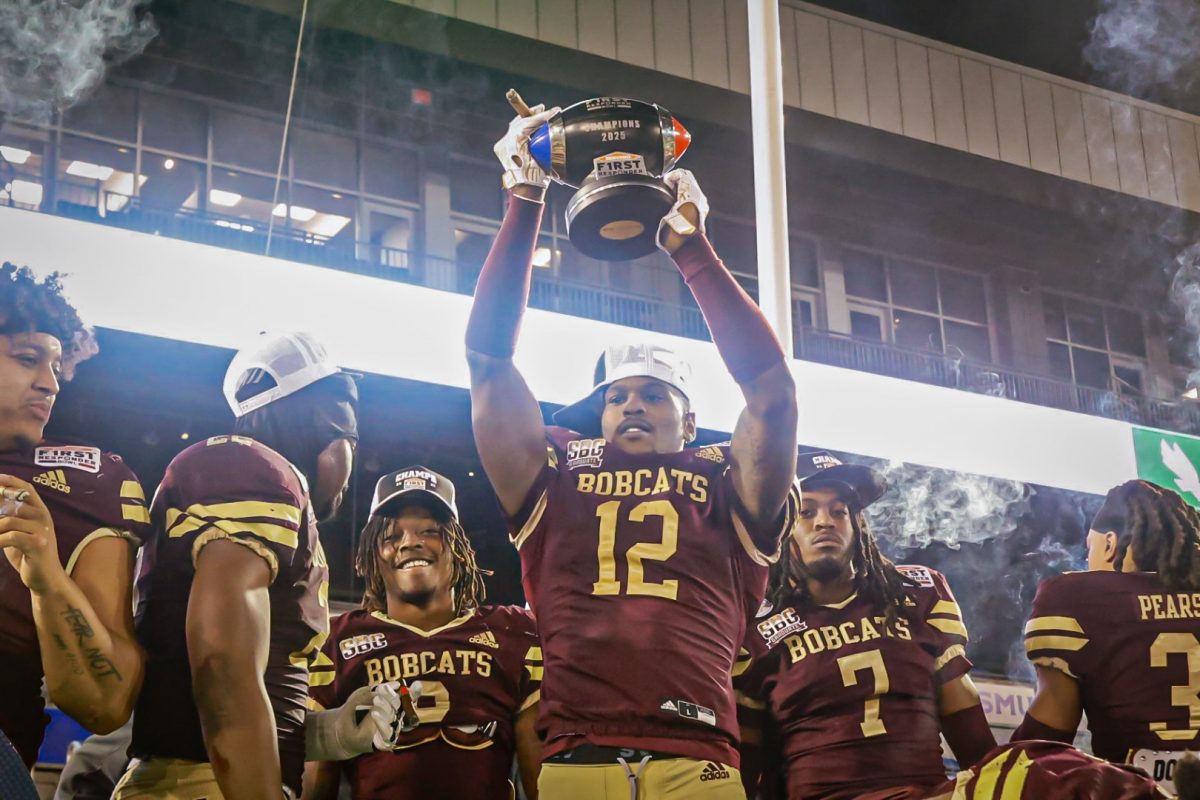 Texas State redshirt senior safety Tory Spears (12) holds up the SERVPRO First Responder Bowl trophy after the win against North Texas, Friday, Jan. 3, 2025, at Gerald J. Ford Stadium.