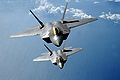 Two F-22 Raptors fly over the Pacific Ocean during a theater security mission March 9 as part of a deployment to Andersen Air Force Base, Guam. The Raptors are deployed from Elmendorf AFB, Alaska.