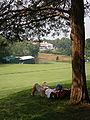 A caddy resting while waiting for his group to tee off, next to the fairway of the 18th hole of the Congressional Country Club's Blue Course during the Earl Woods Memorial Pro-Am prior to the 2007 AT&T National tournament.