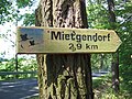 Direction sign to Mietgendorf with cranes, symbol of the Naturpark Nuthe-Nieplitz (nature park).