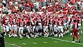 The 2007 football team huddles together before the start of the game against the Miami Hurricane