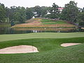 The new 10th hole of the Congressional Country Club's Blue Course during the 2007 AT&T National tournament. This replaced the old 18th hole, which had its tee in the foreground with the green across the water at the bottom left of the hill. The change was presumably made so the 2011 U.S. Open would not end on a par 3.