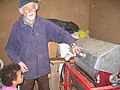 Farmer in Skáleyjar with machine used to dry and clean the eiderdown.