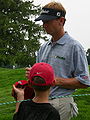 Brad Faxon signing autographs on the 8th green of the Congressional Country Club during the Earl Woods Memorial Pro-Am prior to the 2007 AT&T National tournament.