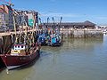 some fishing boats with the 'vistrap' in the background