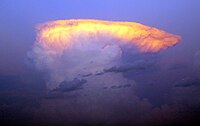 The setting sun captures the top of a classic anvil-shaped thunderstorm cloud in east central Nebraska.