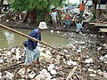 Man walking on a pile of garbage, Jakarta