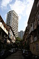 A typical 'gully' (street) of 'chawls' (one room dwellings). Note the contrast between the haves and have nots in Mumbai.