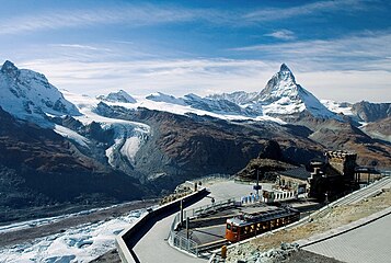 Matterhorn (far before), viewed from Gornergrat railway station and, from left to right, Klein Matterhorn, Breithorn, the nowadays disconnected Lower Theodul Glacier and Upper Theodul Glaciers (June 2006).