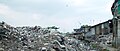 A mountain of trash next to slums, Jakarta