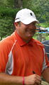 Jason Gore signing autographs on the 4th green of the Congressional Country Club's Blue Course during the Earl Woods Memorial Pro-Am prior to the 2007 AT&T National tournament.