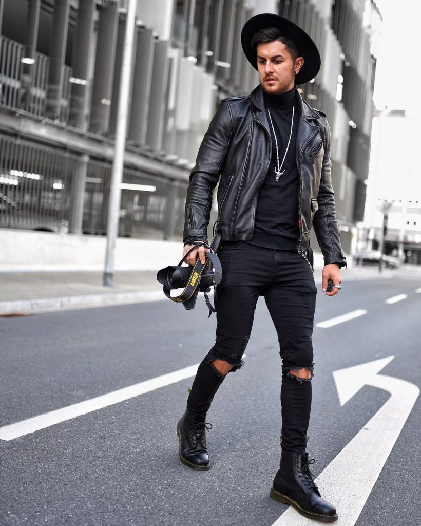 Leather biker jacket, sweater, jeans, leather boots, fedora hat