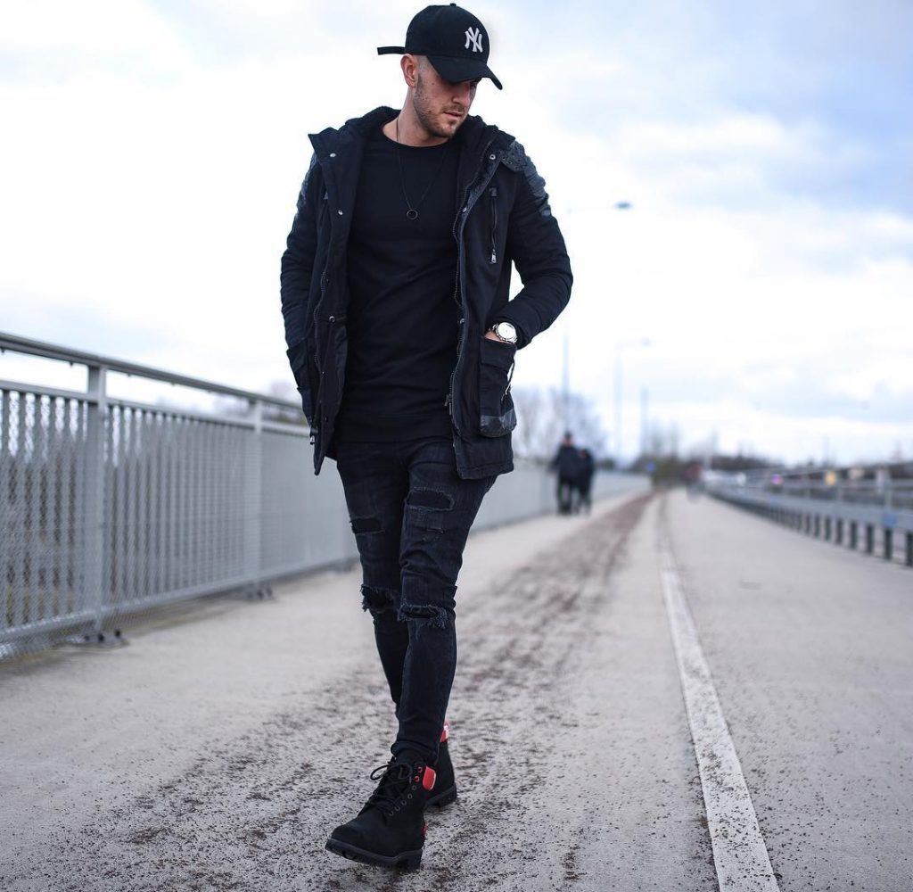 Black parka jacket, tee, jeans, sneaker, baseball cap