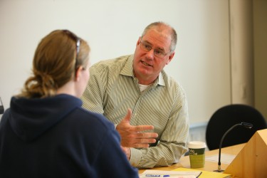 UW faculty member talking with a student.