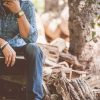 Man sitting in jeans with travel journal