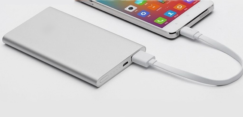 Plain white powerbank plugged into smartphone