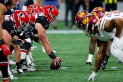 ATLANTA, GEORGIA - OCTOBER 15: Washington Commanders and Atlanta Falcons line up for a play during the first half at Mercedes-Benz Stadium on October 15, 2023 in Atlanta, Georgia. (Photo by Kevin C. Cox/Getty Images)