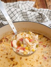 Creamy Chicken Corn Soup in Dutch oven with ladle