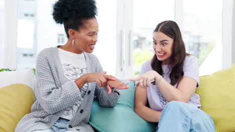 Friends,-women-and-wedding-ring-on-sofa-laughing