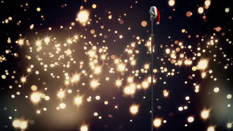 Santa-hat-over-microphone-against-golden-spots-of-light-against-black-background