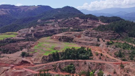 Aerial-forward-flight-towards-FALCONBRIDGE-MIne-Plant-in-Dominican-Republic-during-summer---Mountain-landscape-in-backdrop