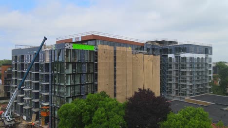 Aerial-view-of-the-exterior-of-a-building-in-construction,-windows-and-balconies-installed